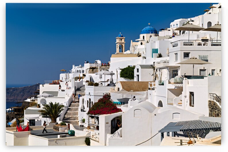 Santorinis iconic white buildings blue domes and caldera view by Marco Brivio