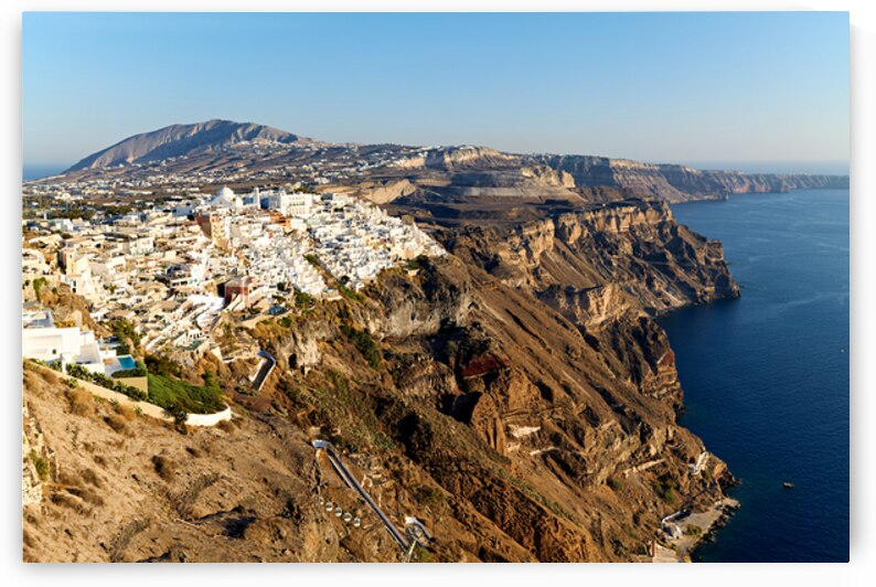 Santorinis white buildings on caldera cliffs above the sea. by Marco Brivio