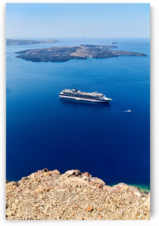 Cruise ship in deep blue sea volcanic islands rocky foreground by Marco Brivio