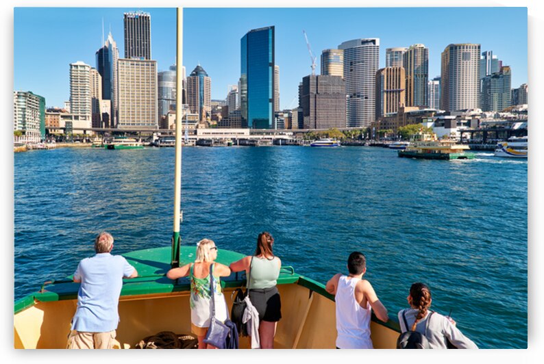 People on ferry enjoy view of Sydney skyline and harbor. by Marco Brivio