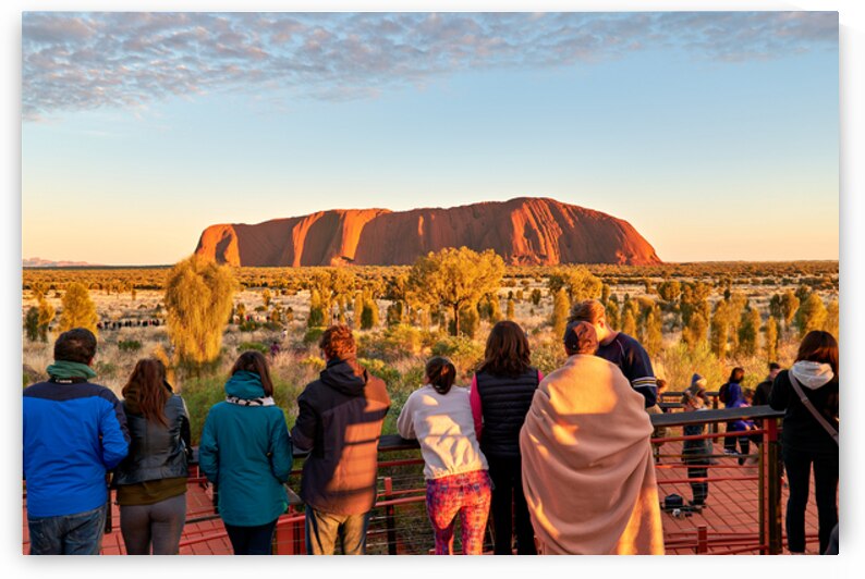 Tourists watch Uluru glow at sunrise. by Marco Brivio