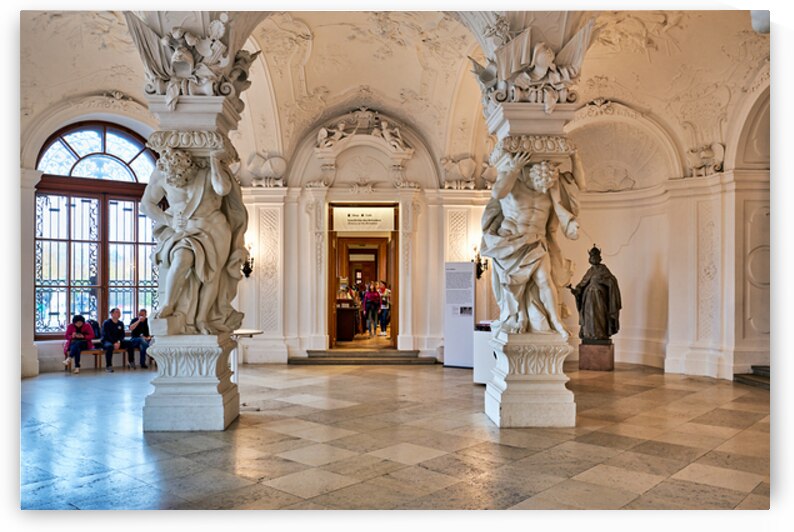 Ornate Baroque hall with sculptures and visitors. by Marco Brivio