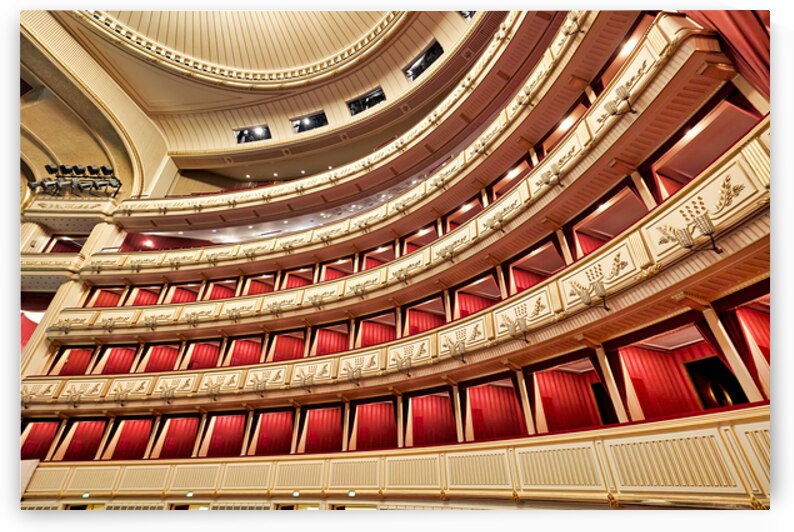 Ornate opera house interior with tiered red and gold balconies. by Marco Brivio
