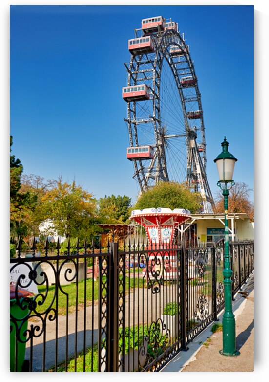 Prater Ferris wheel and carousel under a clear blue sky. by Marco Brivio