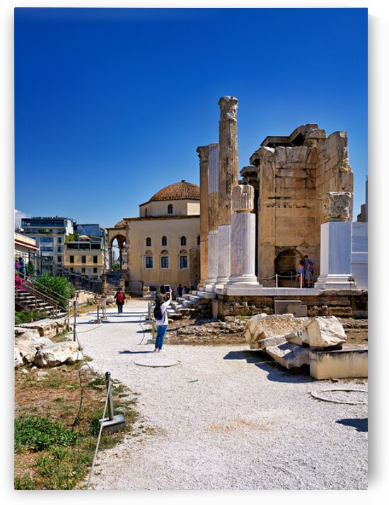 Visitors explore Hadrians Library in Athens Greece under clear by Marco Brivio