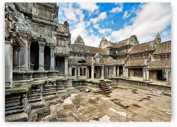 Ancient Angkor Wat temple complex under a blue sky. by Marco Brivio