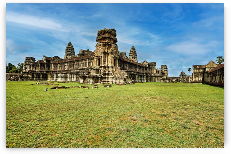 Angkor Wat temple complex with green grass and blue sky. by Marco Brivio