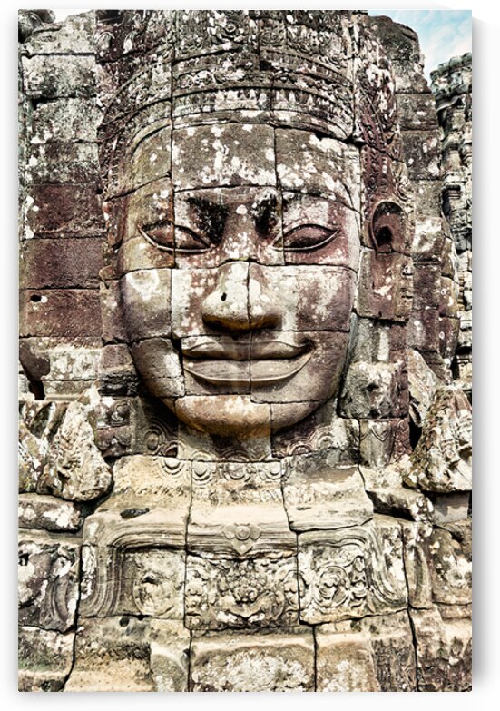 Ancient stone face carving at Bayon temple Cambodia. by Marco Brivio