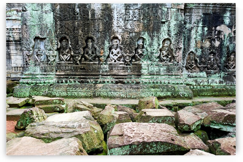 Ancient temple wall carvings and fallen stones covered in moss. by Marco Brivio