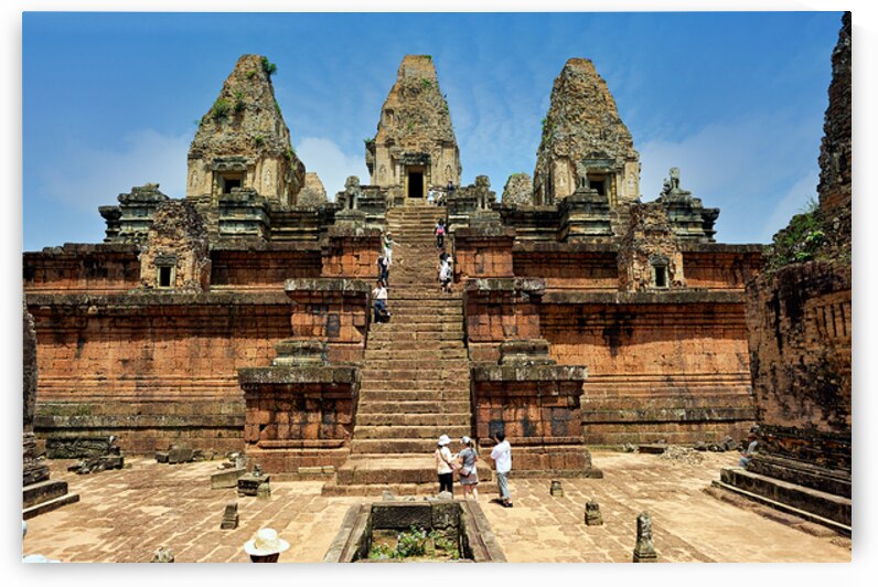 Tourists explore ancient Cambodian temple ruins. by Marco Brivio
