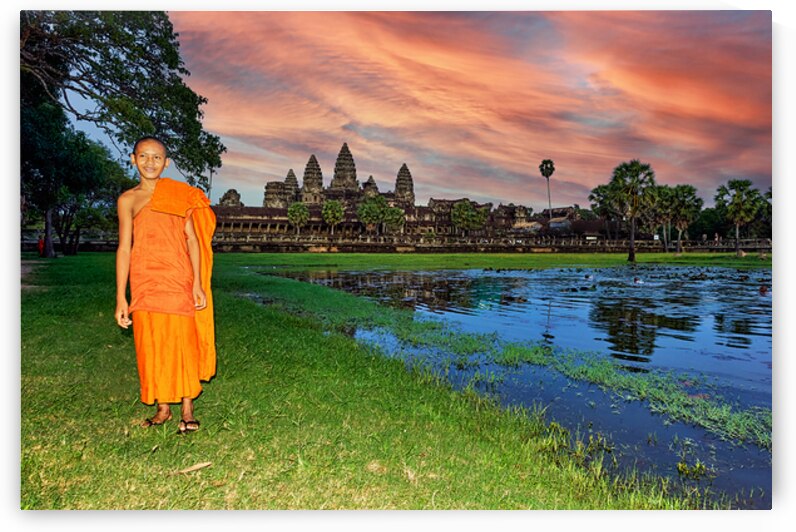 Monk stands by pond with Angkor Wat and sunset sky. by Marco Brivio