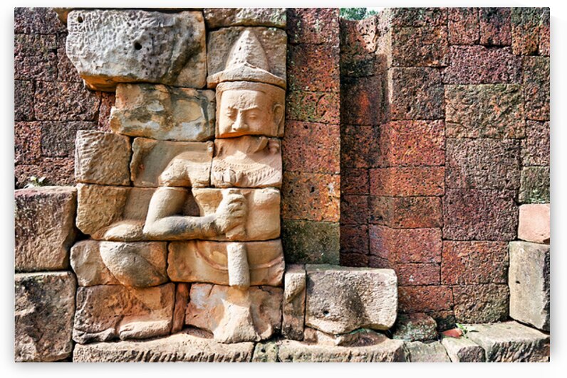 Ancient Khmer stone carving on a weathered temple wall. by Marco Brivio
