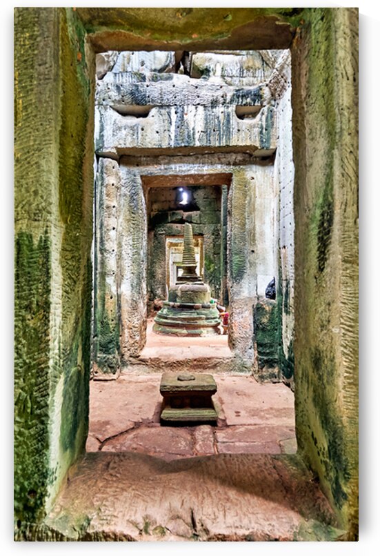 Weathered stone temple interior leading to a tiered stupa. by Marco Brivio