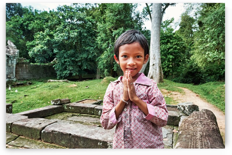 Smiling child offers traditional greeting at ancient temple ruin by Marco Brivio