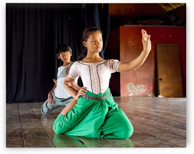 Young dancers in traditional attire practicing graceful poses. by Marco Brivio