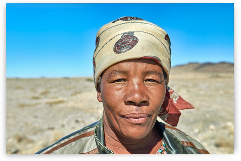 Portrait of a woman in Namibia with clear blue sky background by Marco Brivio
