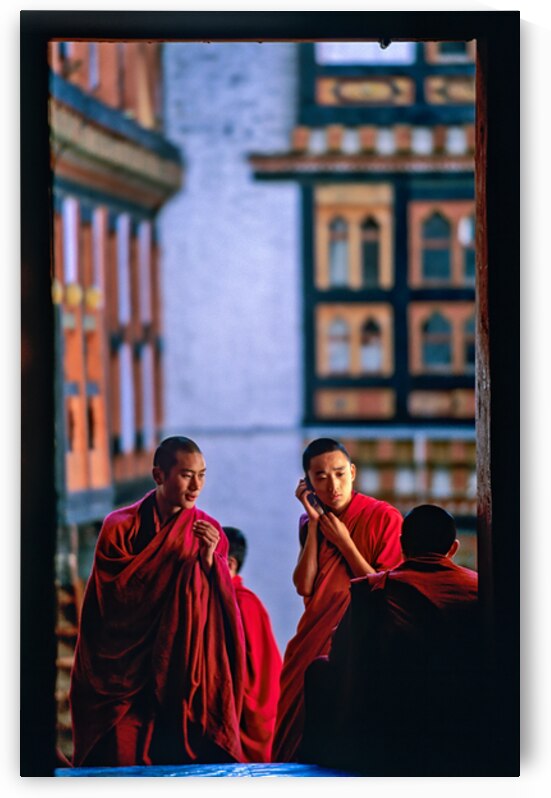 Bhutanese monks using a mobile phone. by Marco Brivio