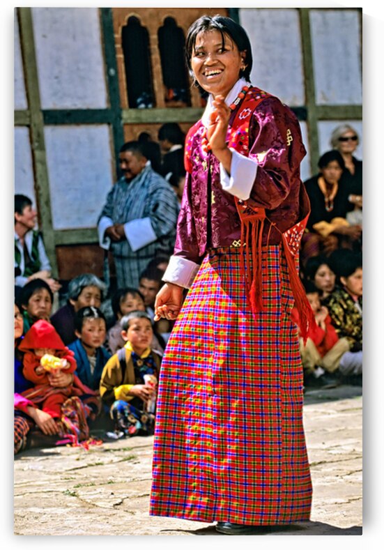 Smiling woman in vibrant Bhutanese traditional dress surrounded by Marco Brivio