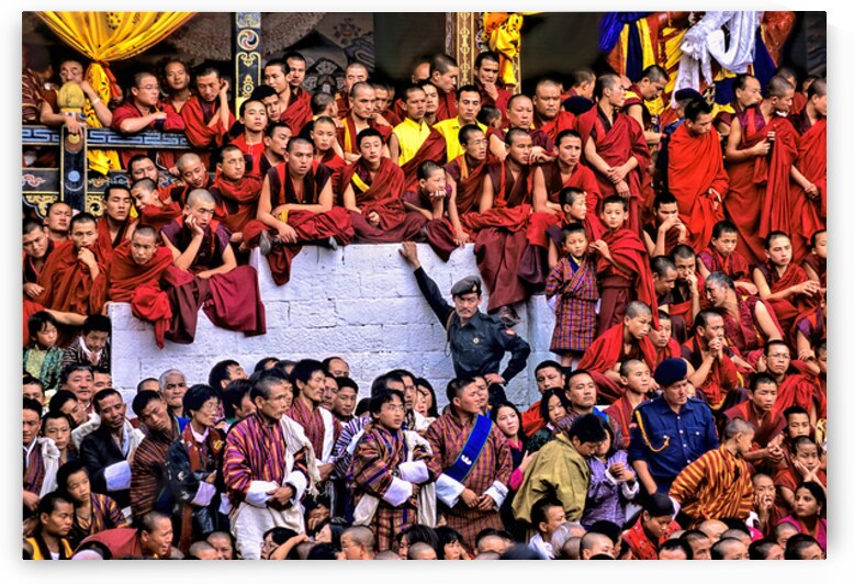Monks and people observe a traditional Bhutanese ceremony. by Marco Brivio