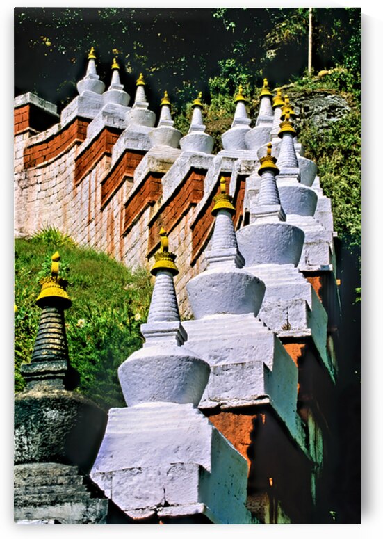 White stupas with golden spires on a green hillside. by Marco Brivio