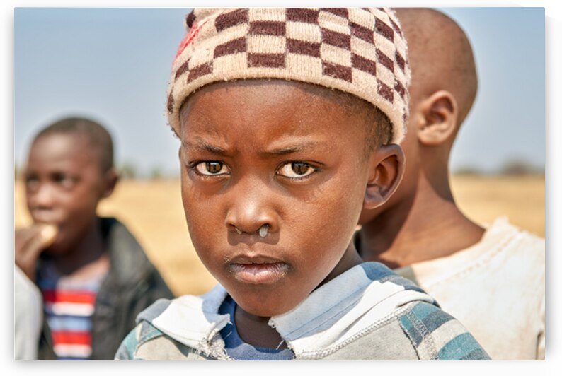 Portrait of a boy in Kavango Region Namibia during the day by Marco Brivio