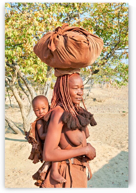 Himba woman carries baby in Kunene region of Namibia by Marco Brivio