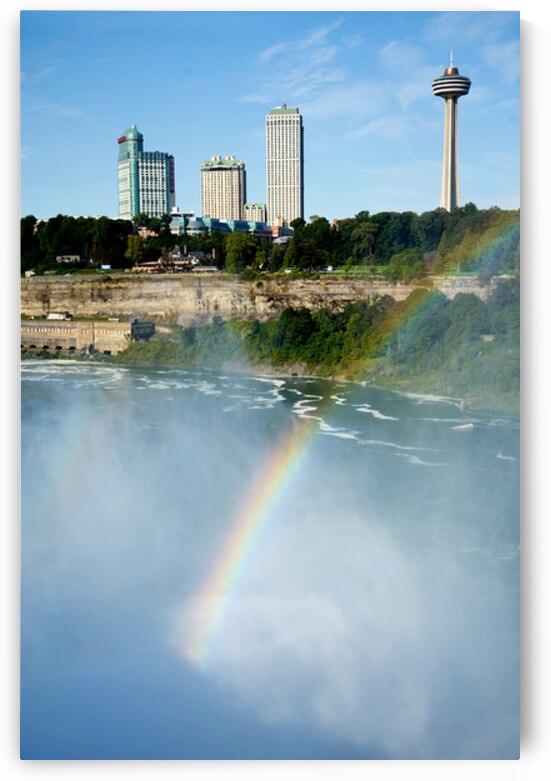 Rainbow over Niagara Falls with city skyline. by Marco Brivio