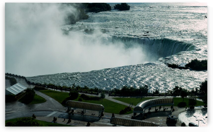Niagara Falls with powerful water mist and surrounding park. by Marco Brivio