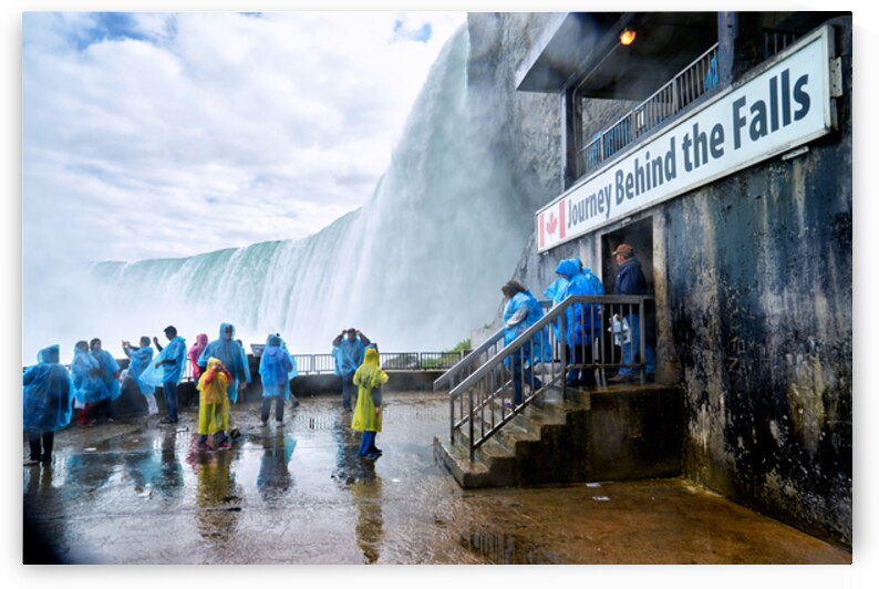 Tourists in ponchos at Niagara Falls Journey Behind the Falls. by Marco Brivio