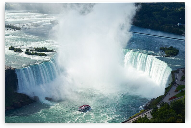 Majestic Niagara Falls a boat braves the mist. by Marco Brivio
