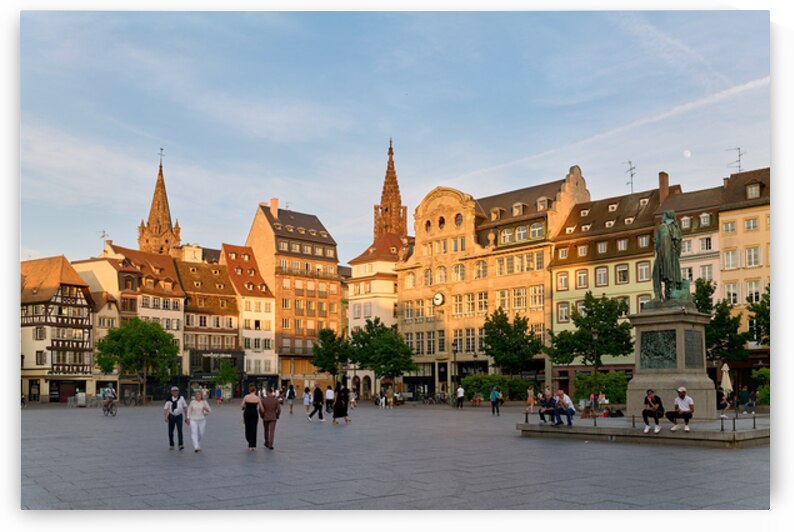 People walk in Place Kleber Strasbourg during the evening glow by Marco Brivio