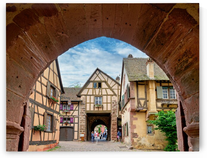 Visitors walk through an archway in Riquewihr by Marco Brivio