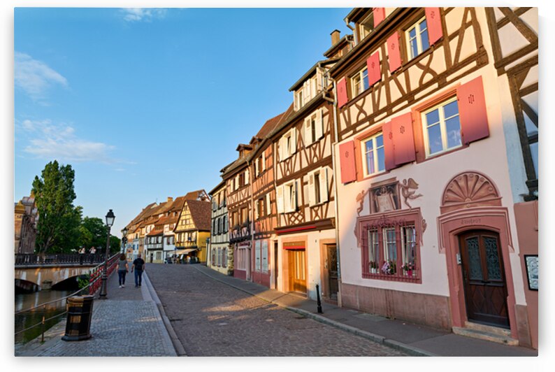 People walking along the canal in Petite Venise Colmar during ev by Marco Brivio