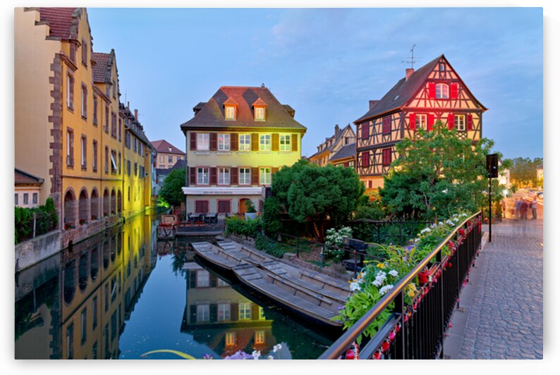 Timber framed houses and visitors in Colmar canals at dusk by Marco Brivio