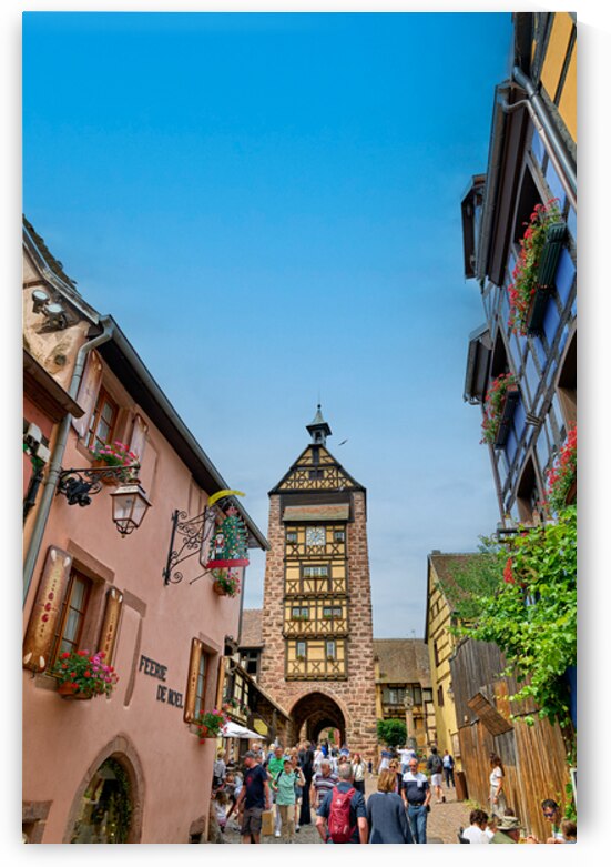 Tourists stroll through historic streets in Riquewihr Alsace by Marco Brivio