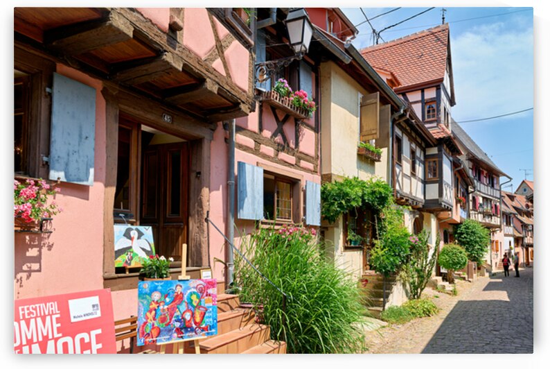 Visitors stroll through Eguisheim on the Alsace Wine Route by Marco Brivio