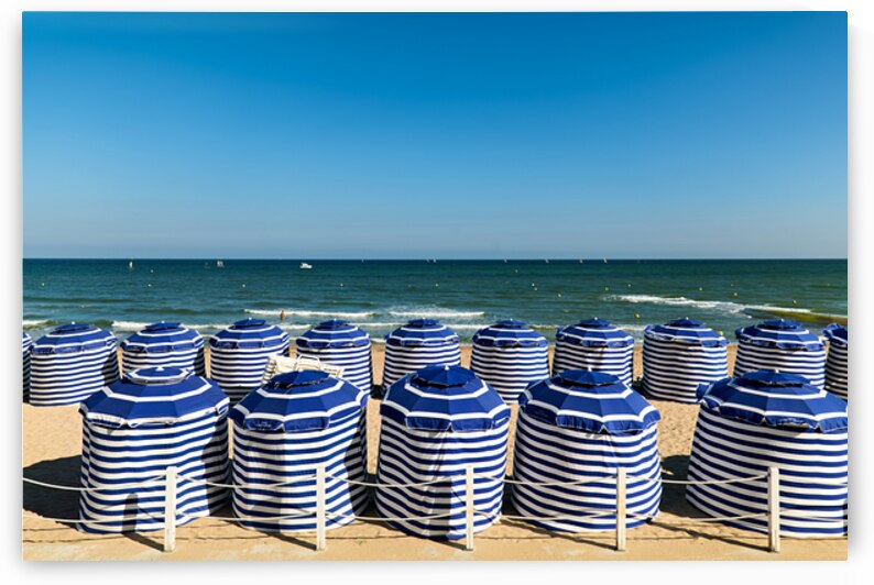 Beach scene in Cabourg Normandy with striped umbrellas on sand by Marco Brivio