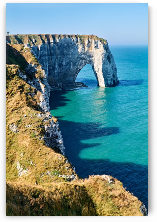 Chalk cliffs of Etretat under a clear sky in Normandy France by Marco Brivio