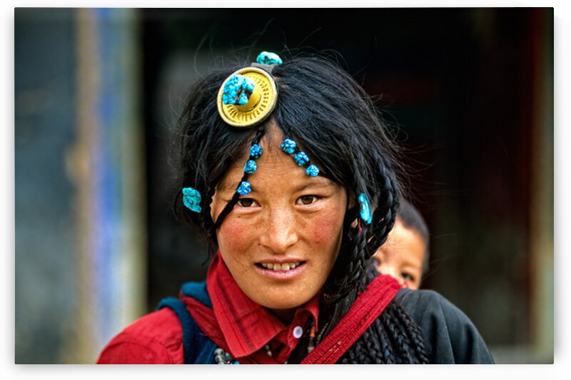Traditional woman carries child in Tibet with ornate hair decora by Marco Brivio