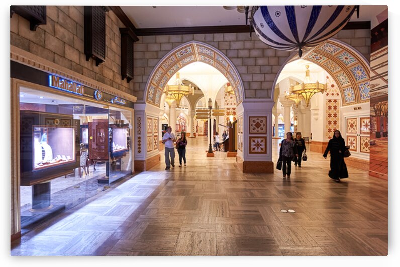 Shoppers explore stores in an Arabian themed mall in Dubai UAE by Marco Brivio
