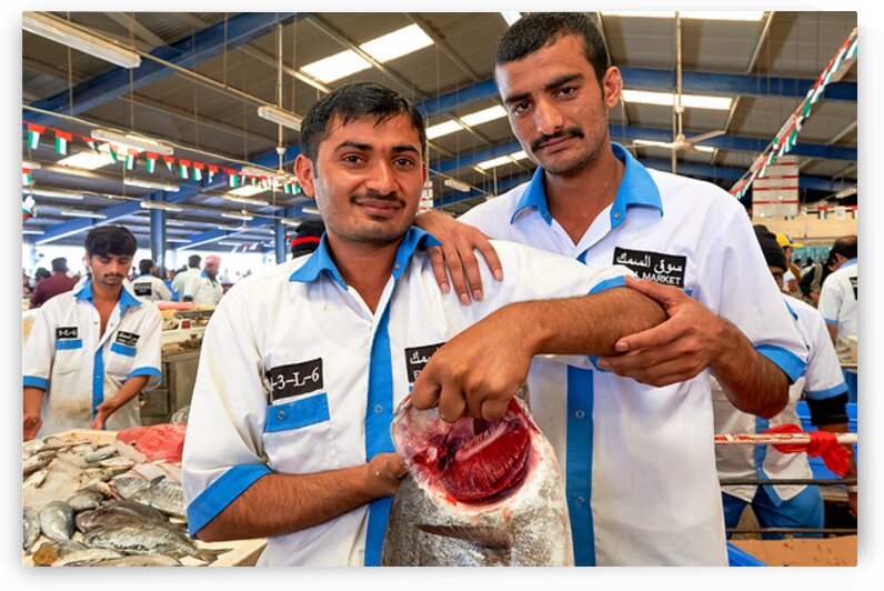 Fishmongers show fresh catch at market in Dubai UAE by Marco Brivio