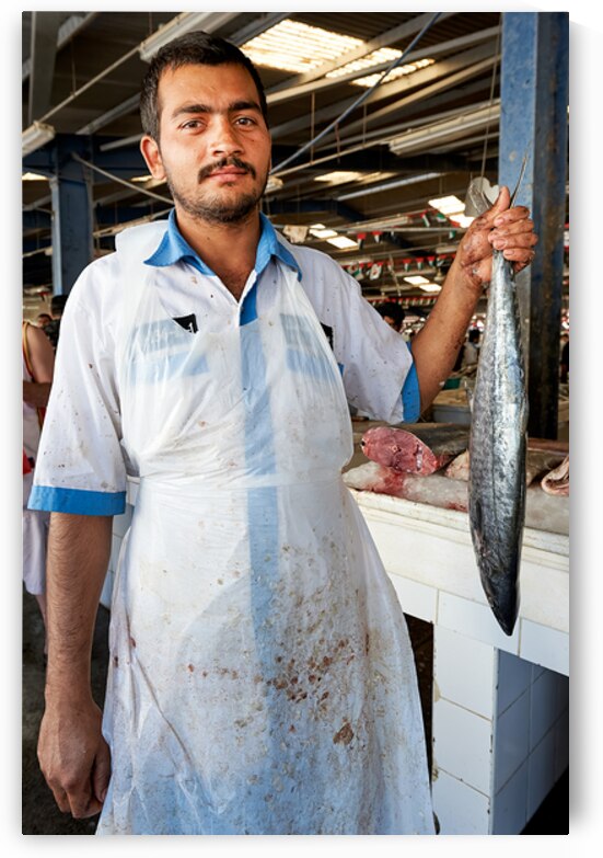 Fish vendor displays his catch at market in Dubai UAE by Marco Brivio