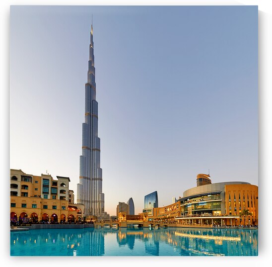 Burj Khalifa stands tall over Dubai skyline with water reflectio by Marco Brivio