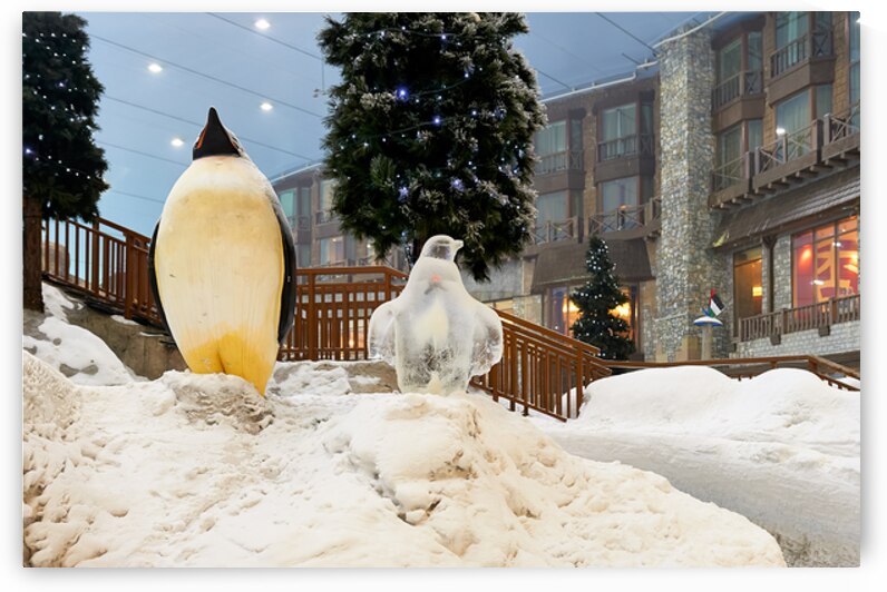 Winter wonderland in Dubai featuring penguin statues and trees by Marco Brivio