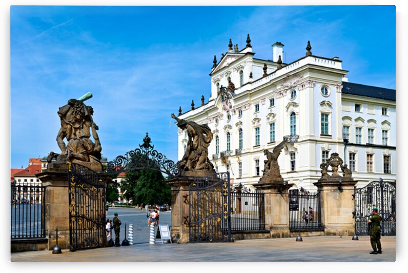 Ornate gates and statues guard a grand European palace. by Marco Brivio