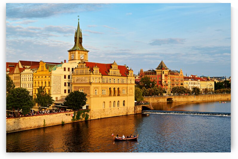 Sunset over Pragues Vltava River historic buildings and boat. by Marco Brivio