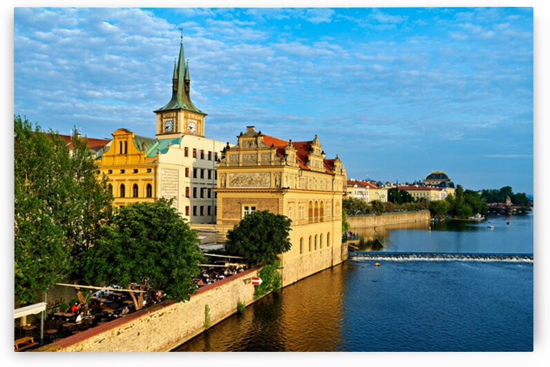 Pragues Vltava riverfront with historic architecture and lively by Marco Brivio