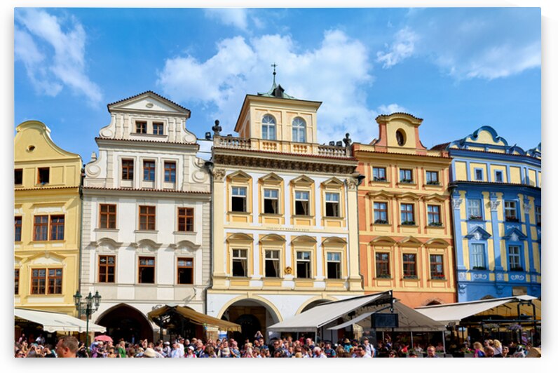 Colorful historic buildings and a lively crowd in a European squ by Marco Brivio