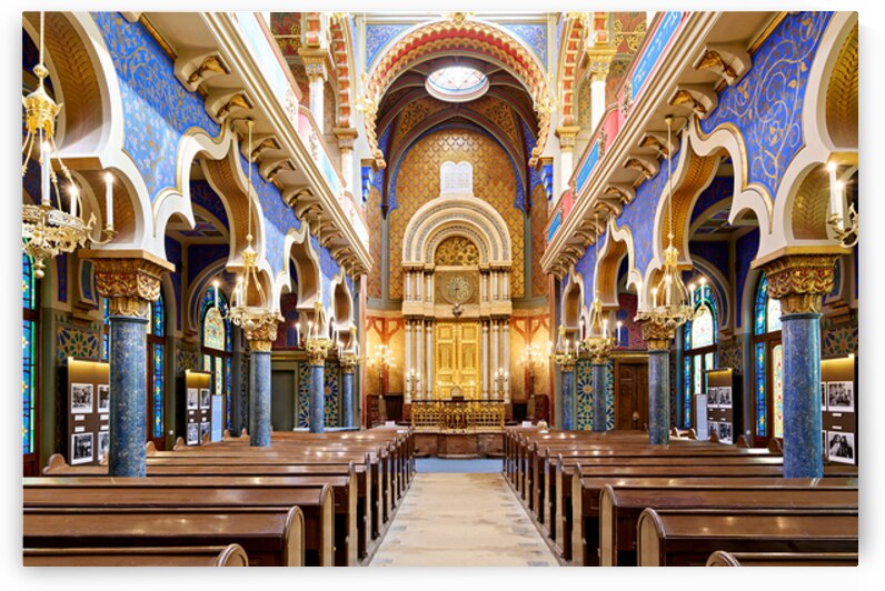 Grand ornate synagogue interior featuring golden ark and pews. by Marco Brivio