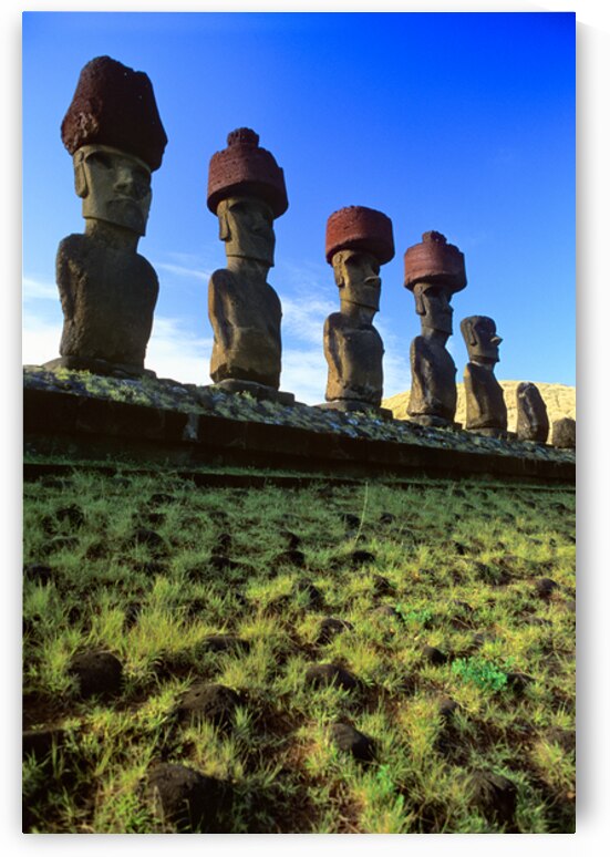Row of Moai statues with red hats on Easter Island. by Marco Brivio
